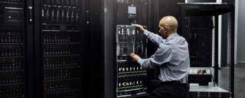 Technician performing maintenance on dedicated server hardware